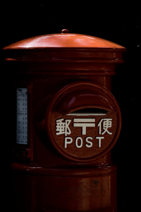 a red fire hydrant with asian writing on it