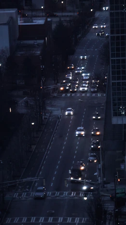 City street at dusk with multiple vehicles highlighted by satellite tracking signals.