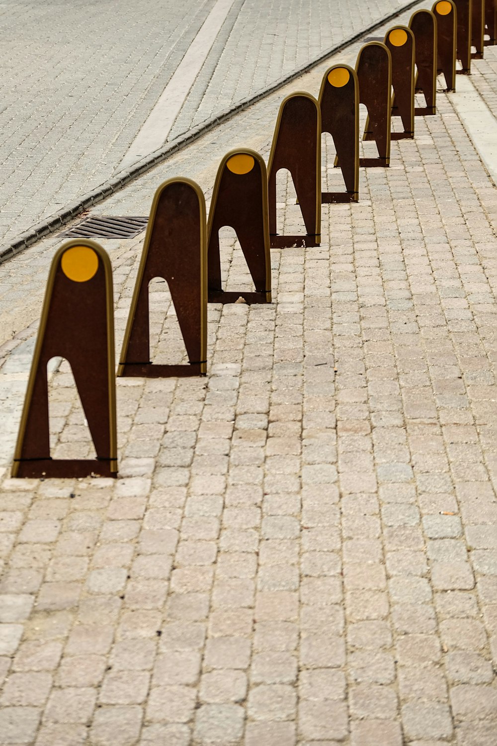 a row of benches sitting on the side of a road