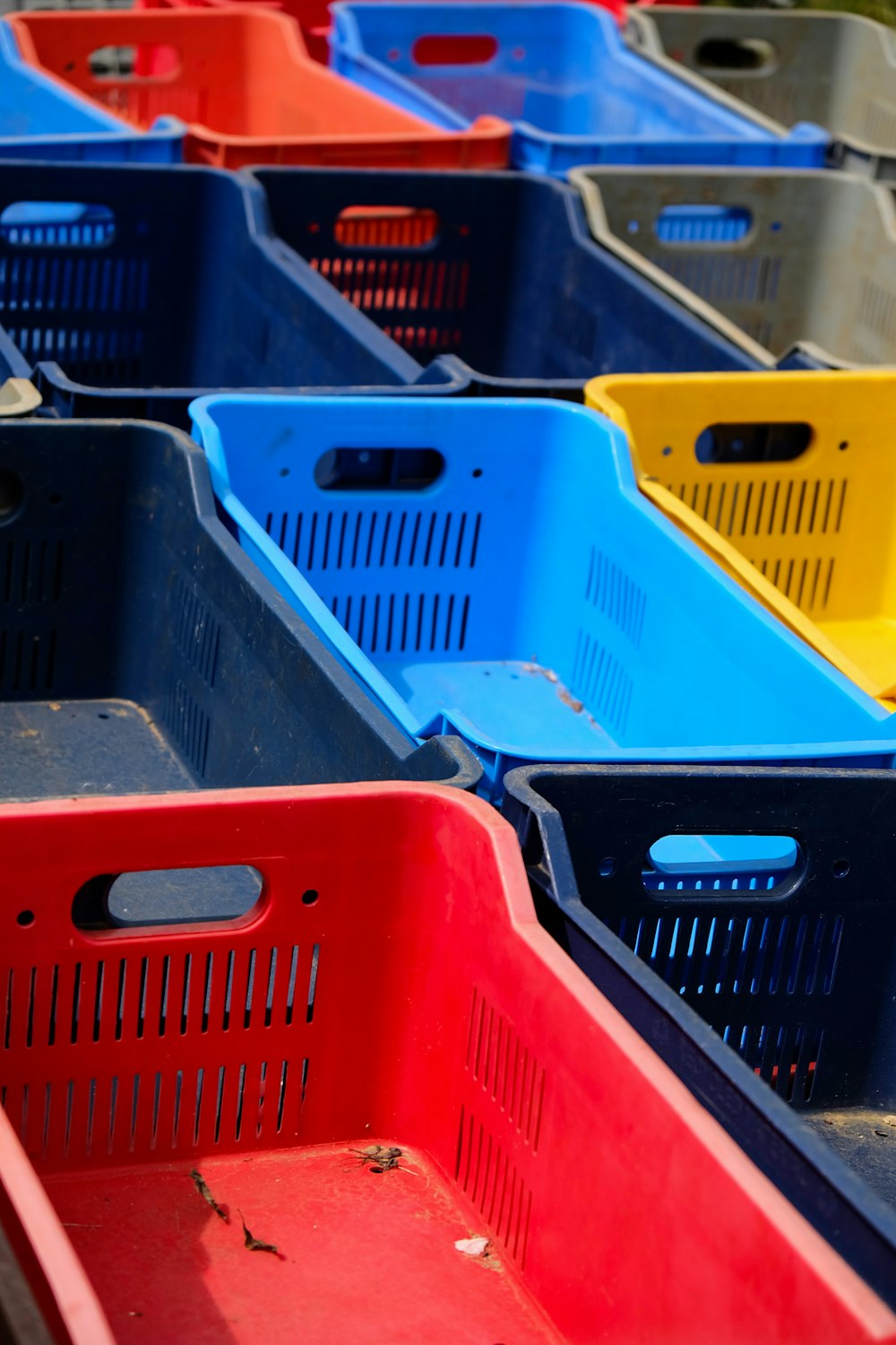 a row of plastic bins sitting next to each other