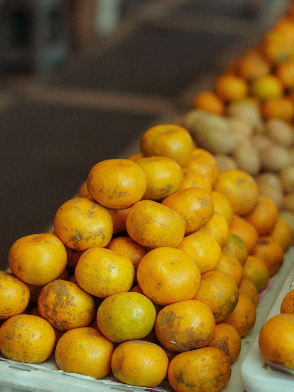 a pile of oranges sitting on top of each other