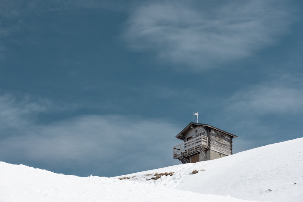 a house on top of a hill covered in snow