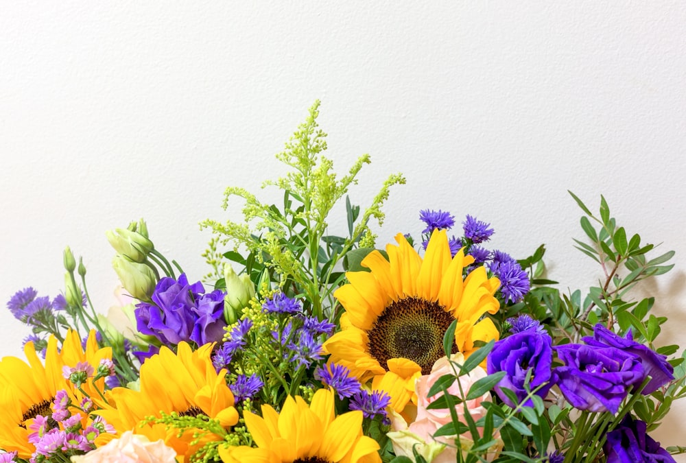 a vase filled with purple and yellow flowers