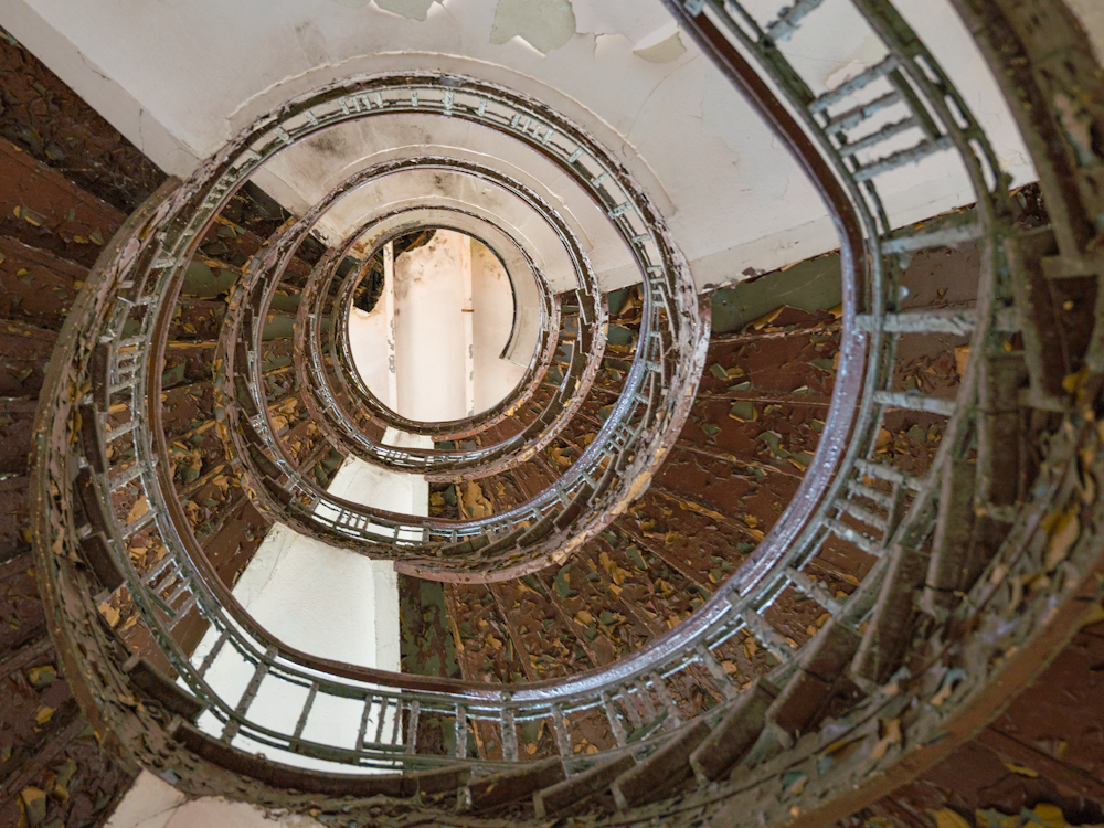 a spiral staircase in a building with glass railings