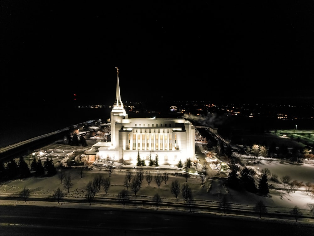 an aerial view of a building lit up at night