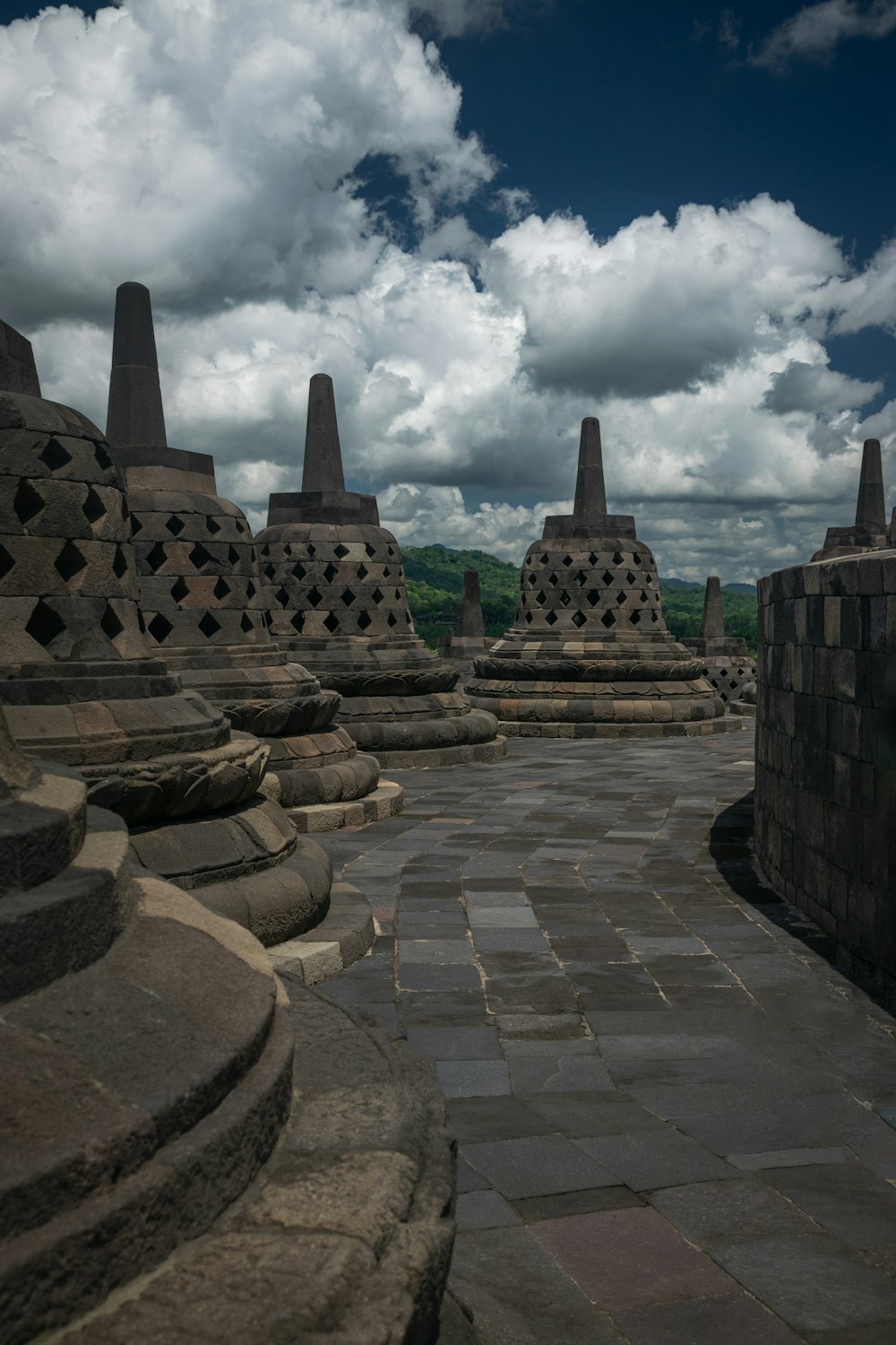 a stone walkway leading to a row of buildings