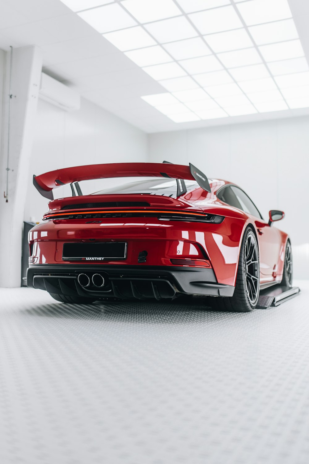 a red sports car parked in a white room