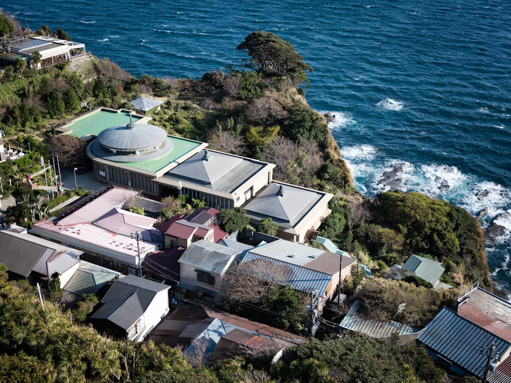 an aerial view of a house on a cliff overlooking the ocean