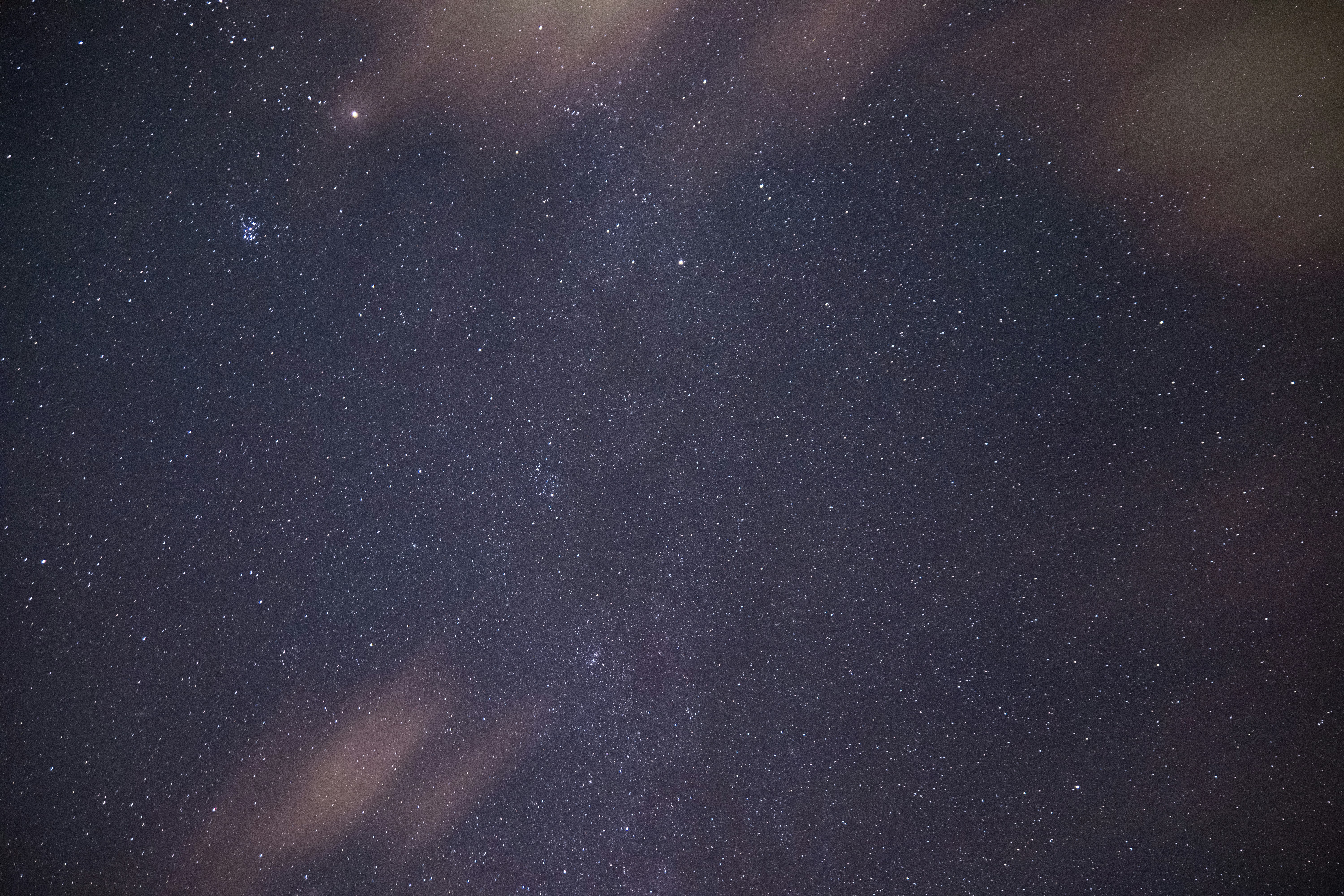 the night sky is filled with stars and clouds