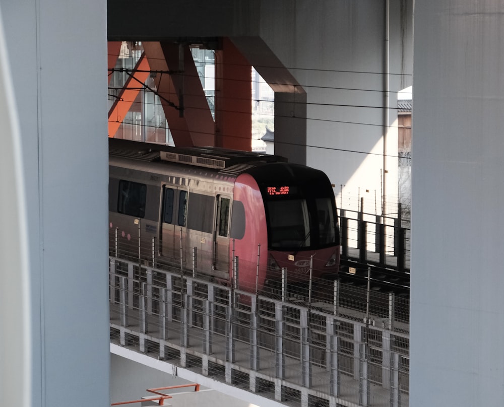 a train traveling through a train station next to tall buildings