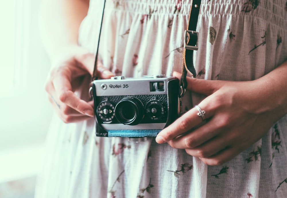 a woman holding a camera in her hands