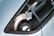 The image features a close-up of a car window with a vinyl wrap logo. The text 'BZRK WRAPS' is prominently displayed in bold and stylized lettering. There are also faint reflections and another symbol resembling an Instagram logo nearby.