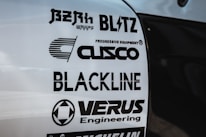 Multiple brand logos are displayed on a white surface, featuring various automotive and engineering companies such as Blitz, Cusco, Blackline, and Verus Engineering. The text is printed in bold black font, each with distinctive logo designs.