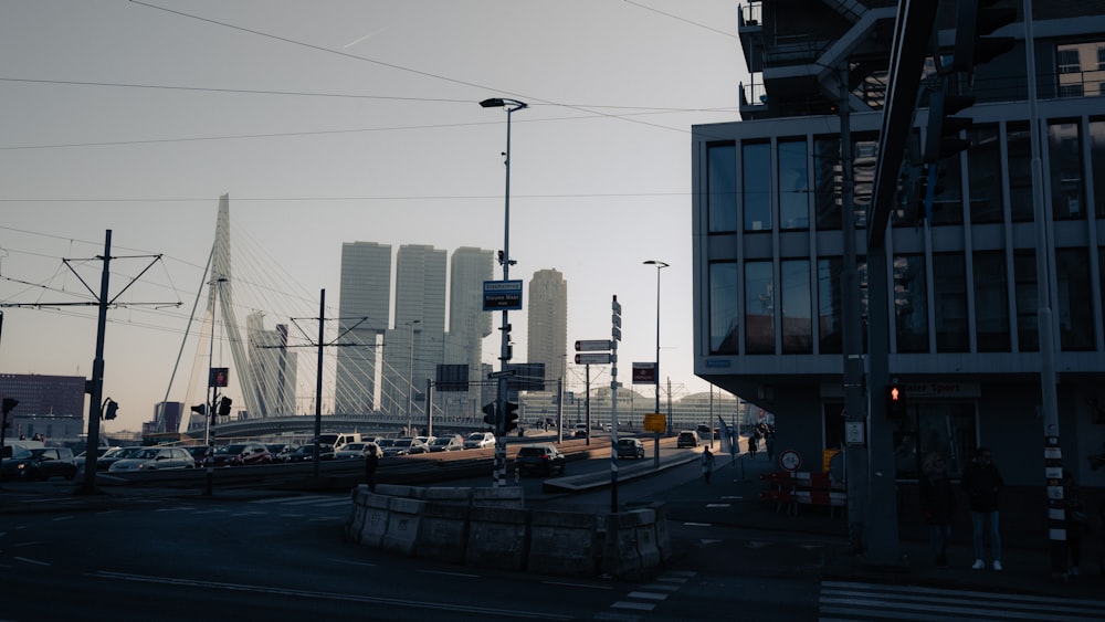 a city street filled with lots of traffic next to tall buildings