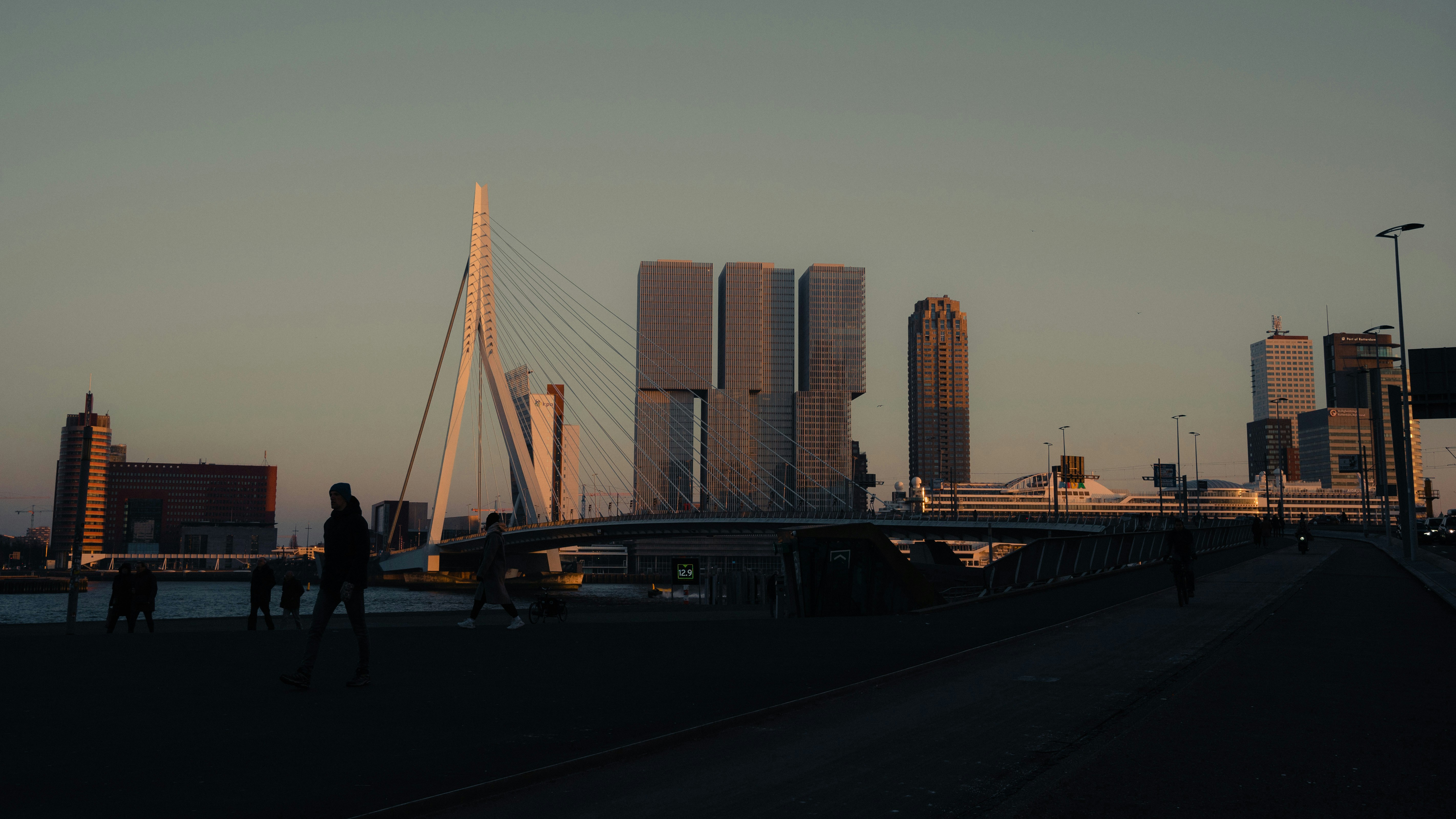 a group of people walking across a bridge