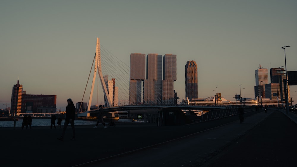 a group of people walking across a bridge