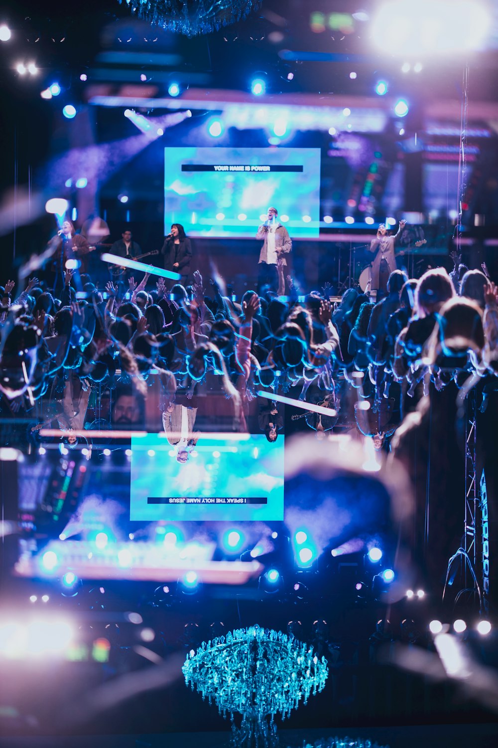 a large group of people standing around a stage