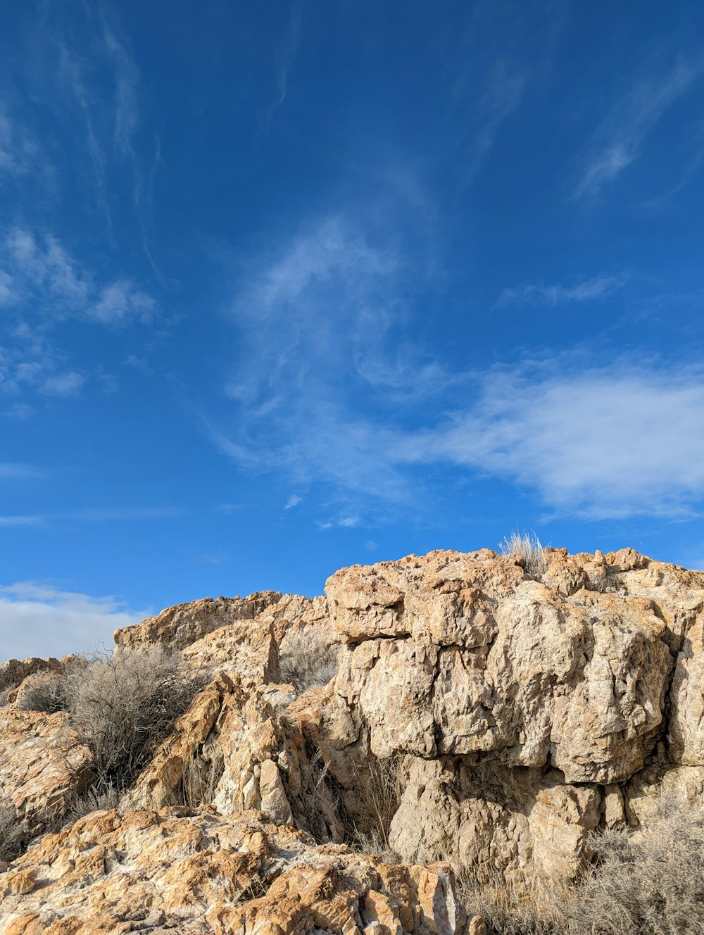 a rocky outcropping with a blue sky in the background