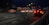 a car driving down a street at night