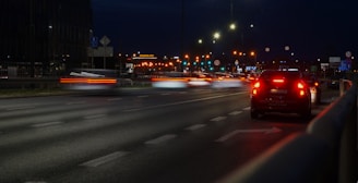a car driving down a street at night