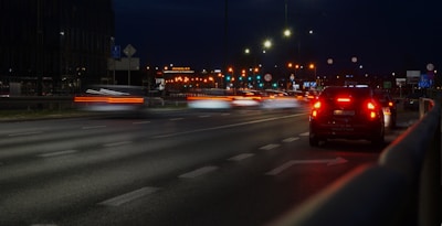 a car driving down a street at night