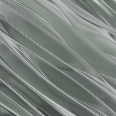 Smooth flowing lines create an abstract pattern, resembling waves or draped fabric. The surface has a glossy, metallic appearance, giving it a sleek and modern aesthetic.