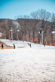 A ski instructor teaching a student on a snowy slope.
