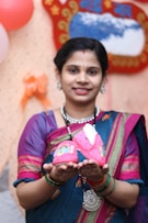a woman holding a pink shoe in her hands