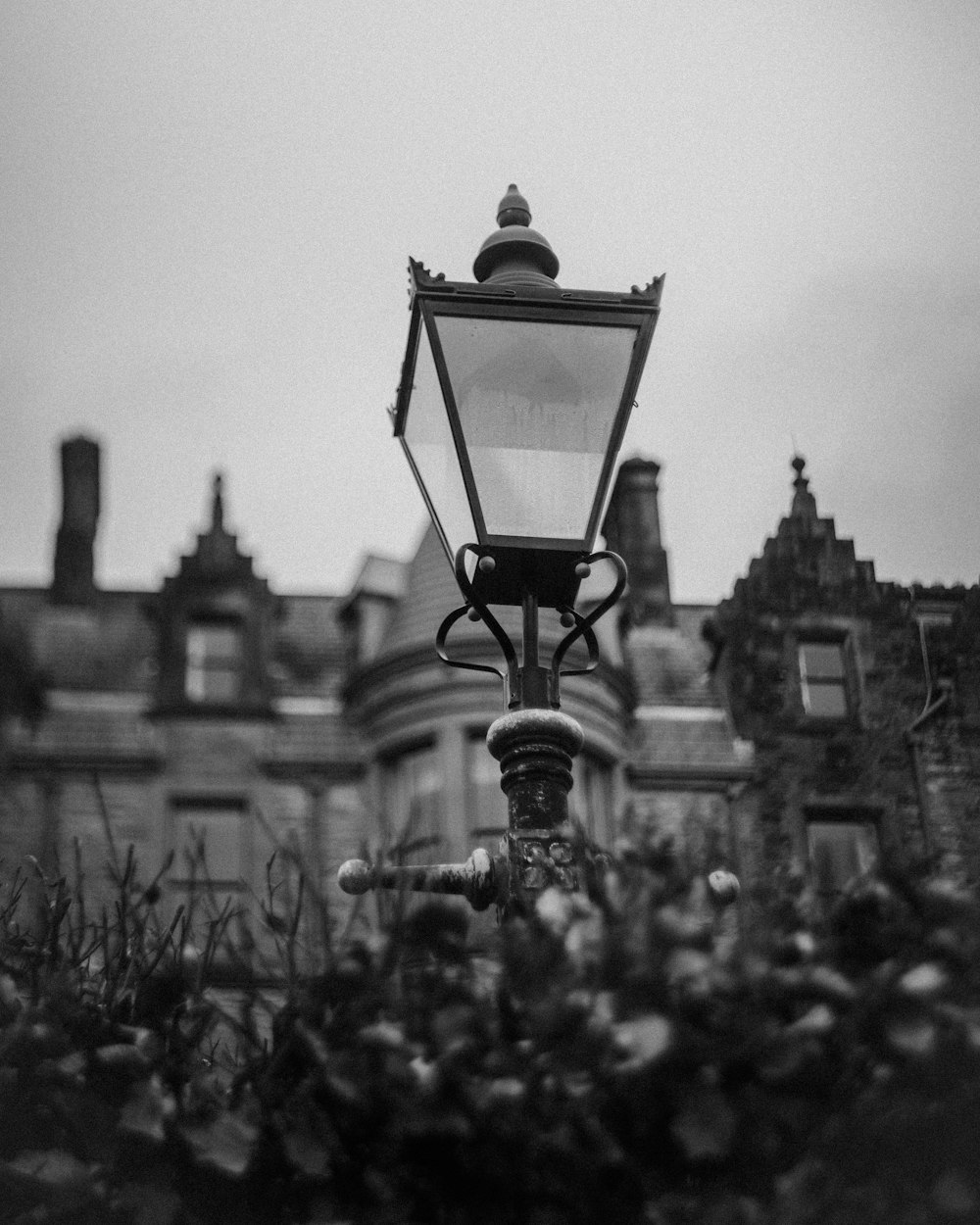 a black and white photo of a street light