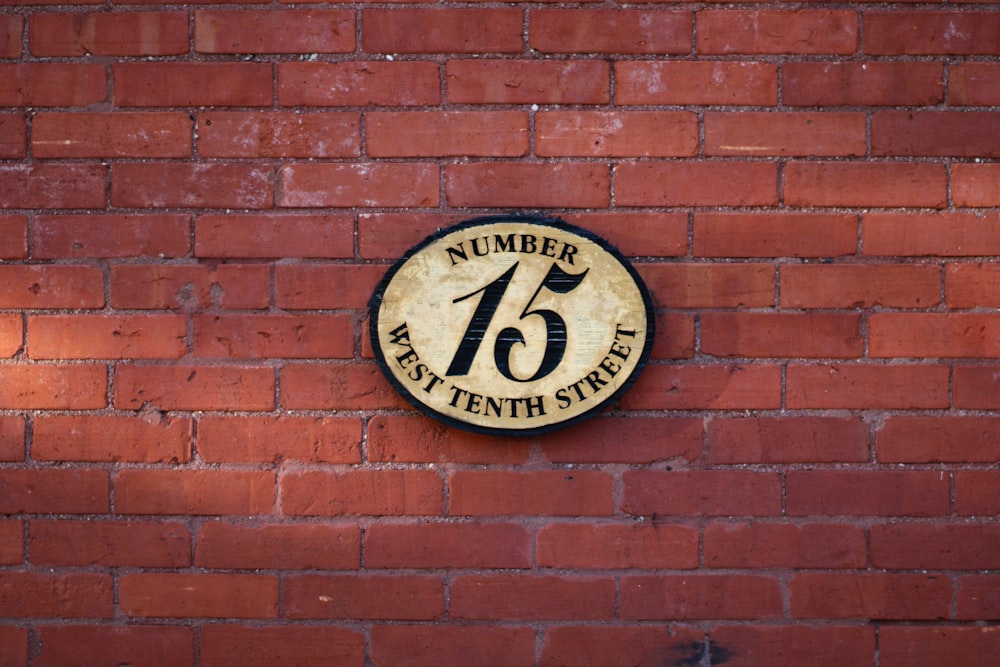 a brick wall with a sign on it that says number sixteen