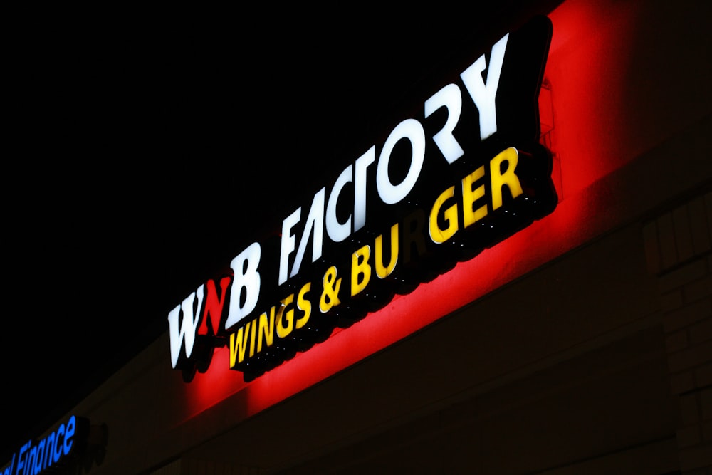 a neon sign is lit up on the side of a building