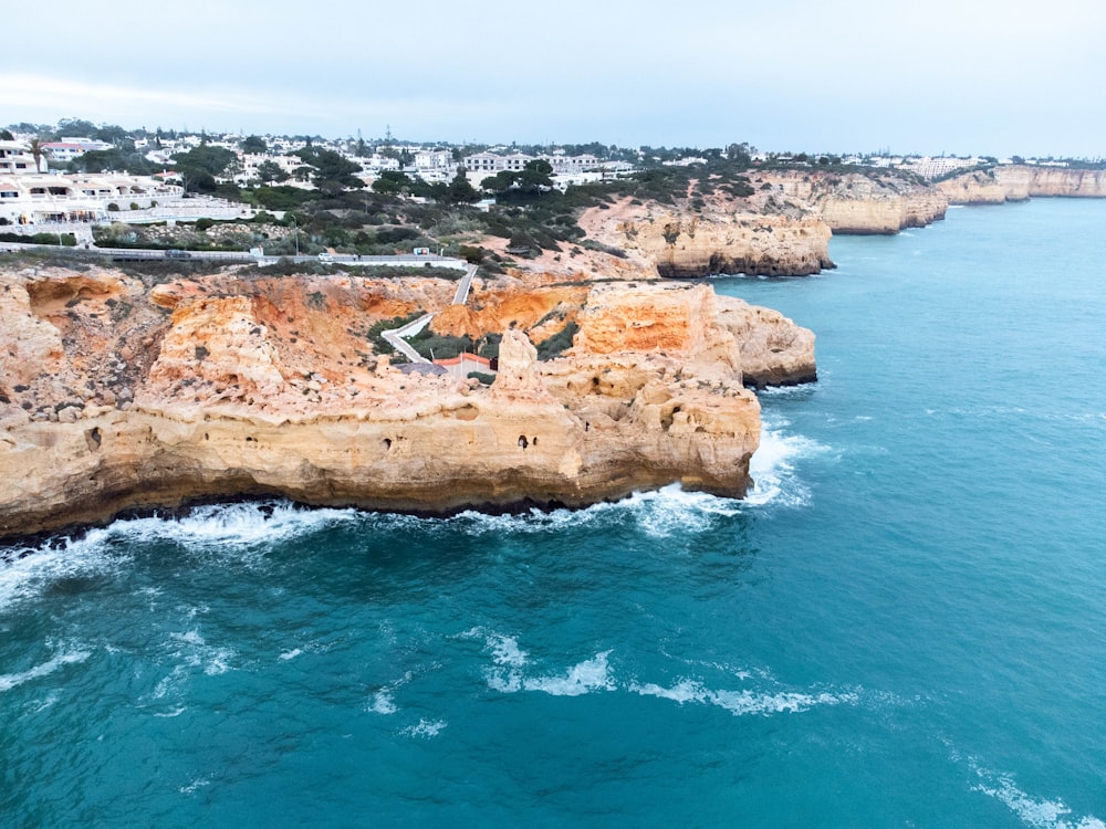 an aerial view of a rocky coastline near a city