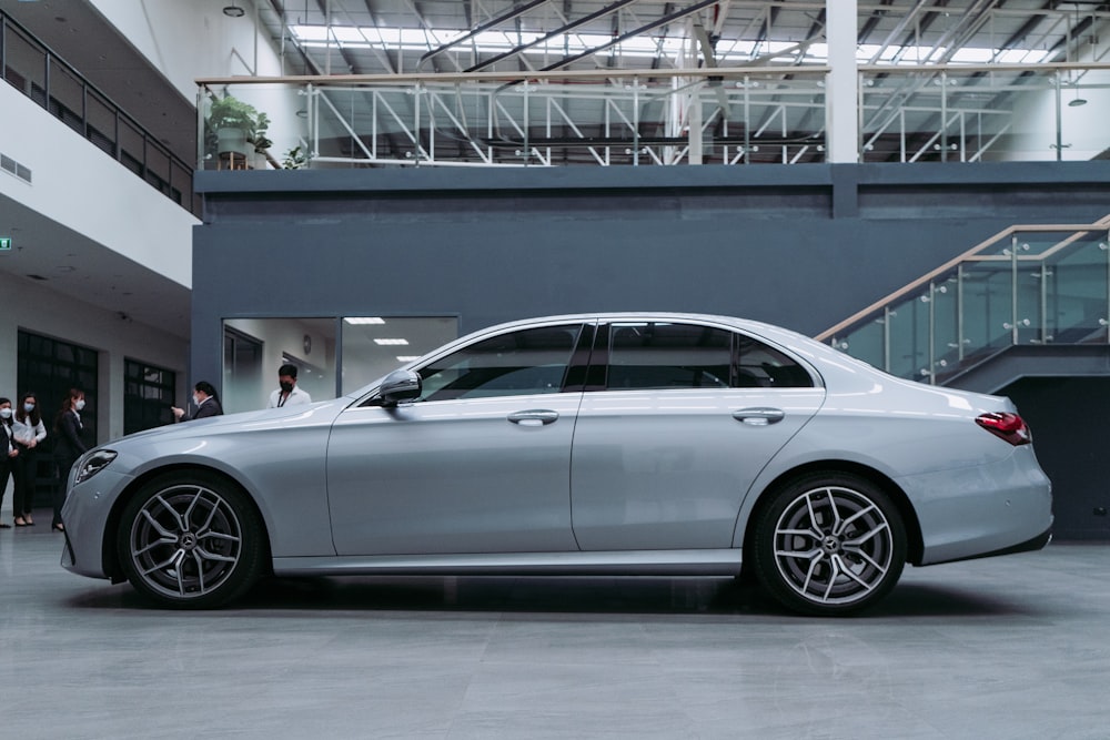 a silver car parked inside of a building