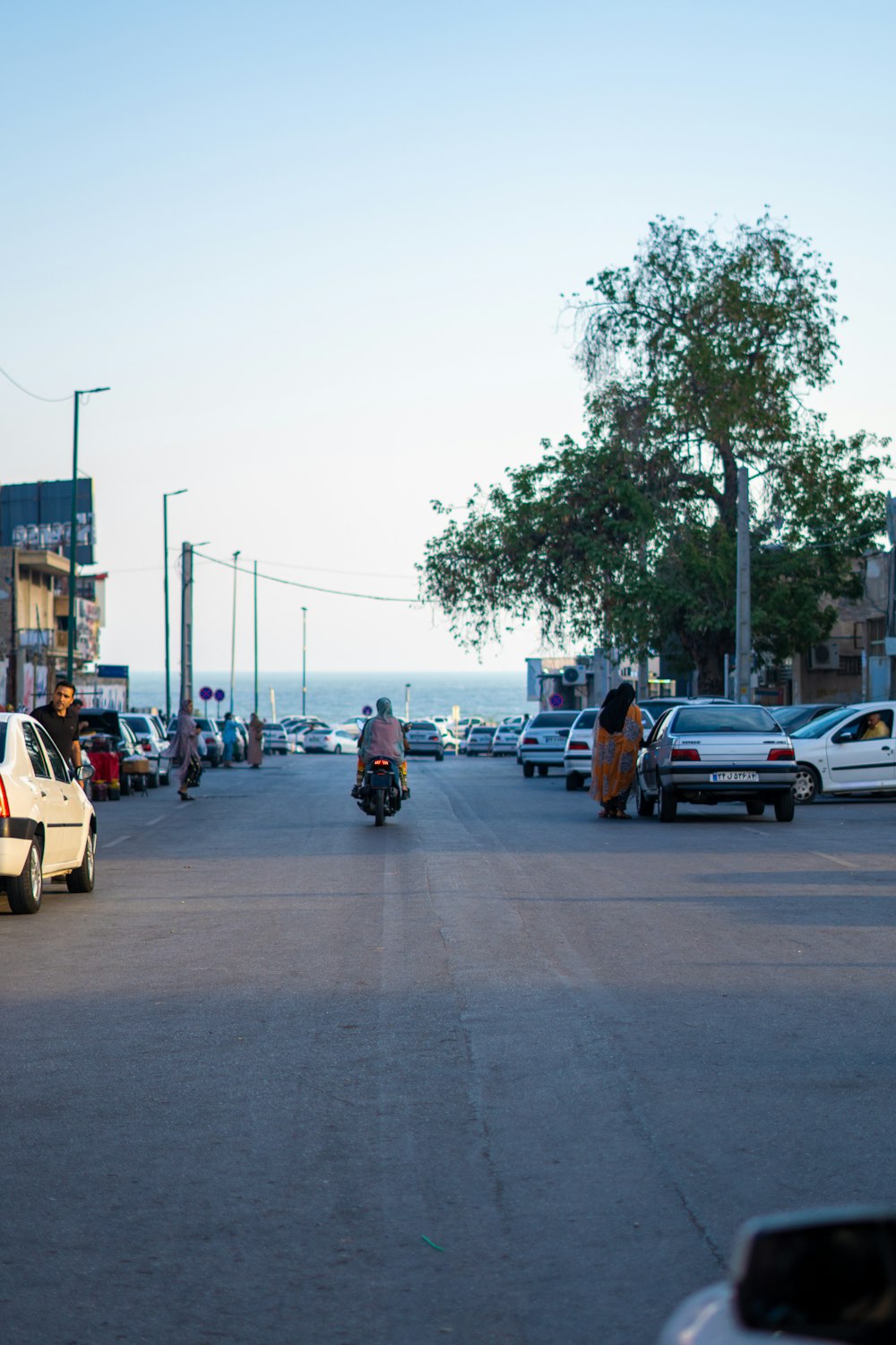 a group of people riding motorcycles down a street