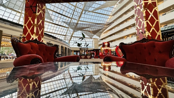 Elegant black and gold office interior with subtle red accents, evoking a refined Parisian private club atmosphere.