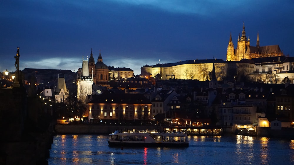 a river with a boat on it and a city in the background