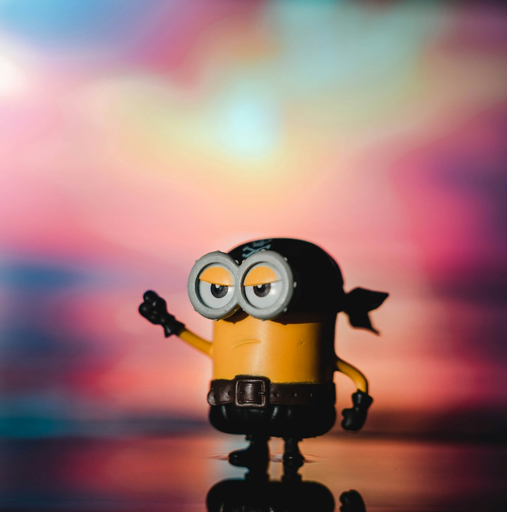a small yellow and black minion with big eyes