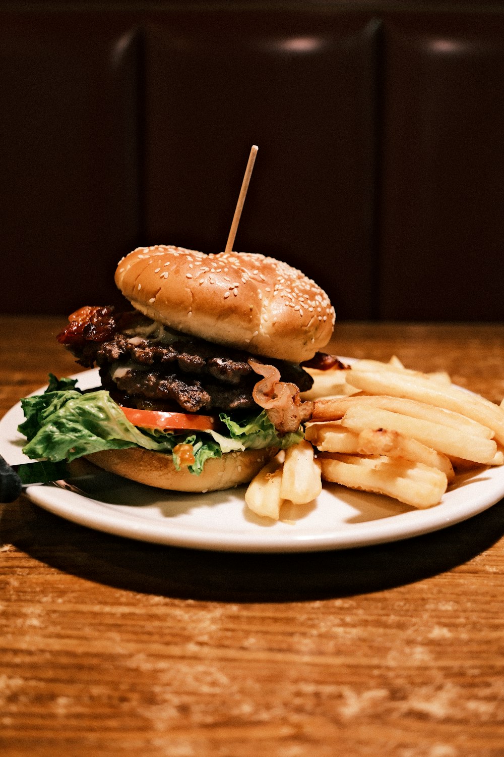 a hamburger and fries on a plate on a table