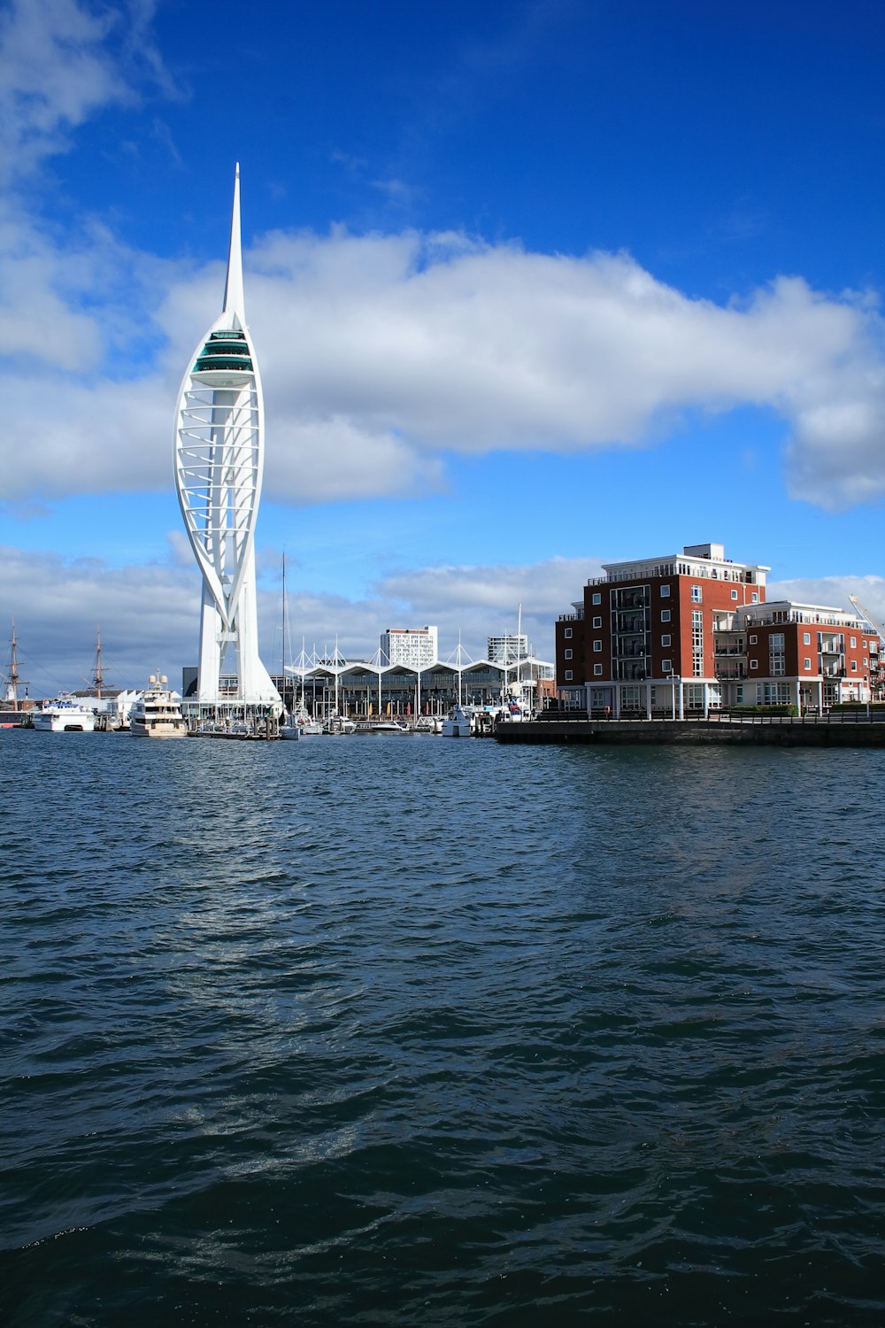 a very tall building sitting in the middle of a body of water