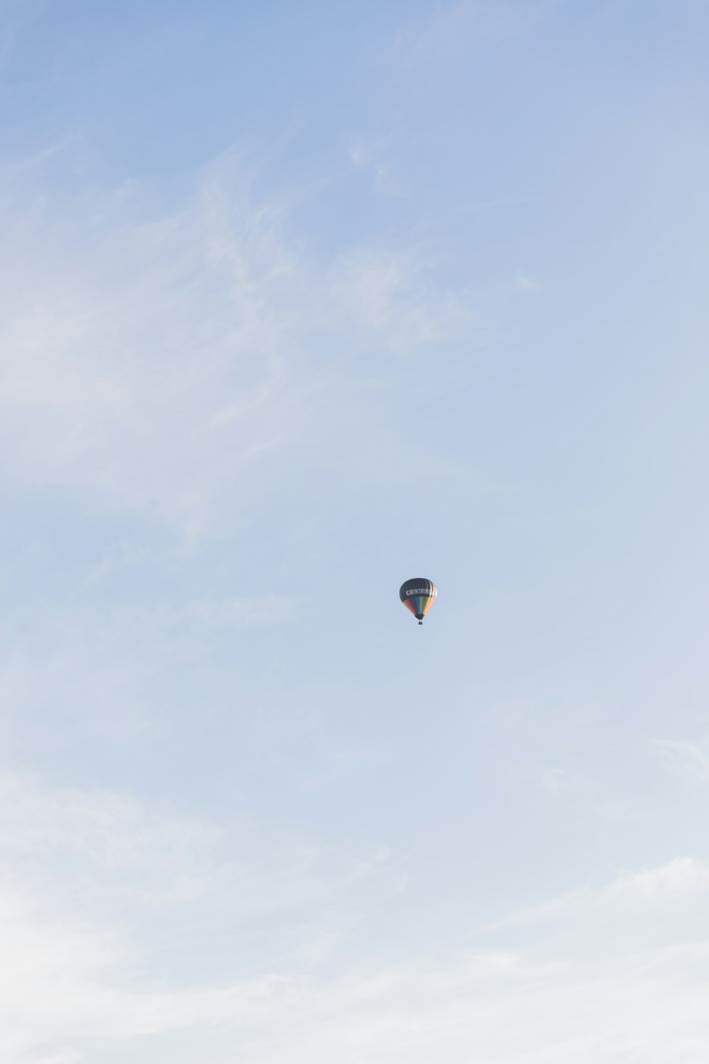 a hot air balloon flying in a blue sky
