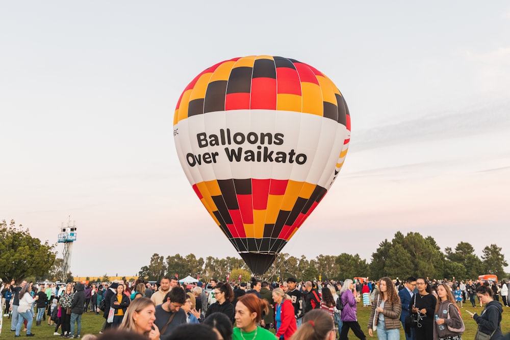 a group of people standing around a hot air balloon