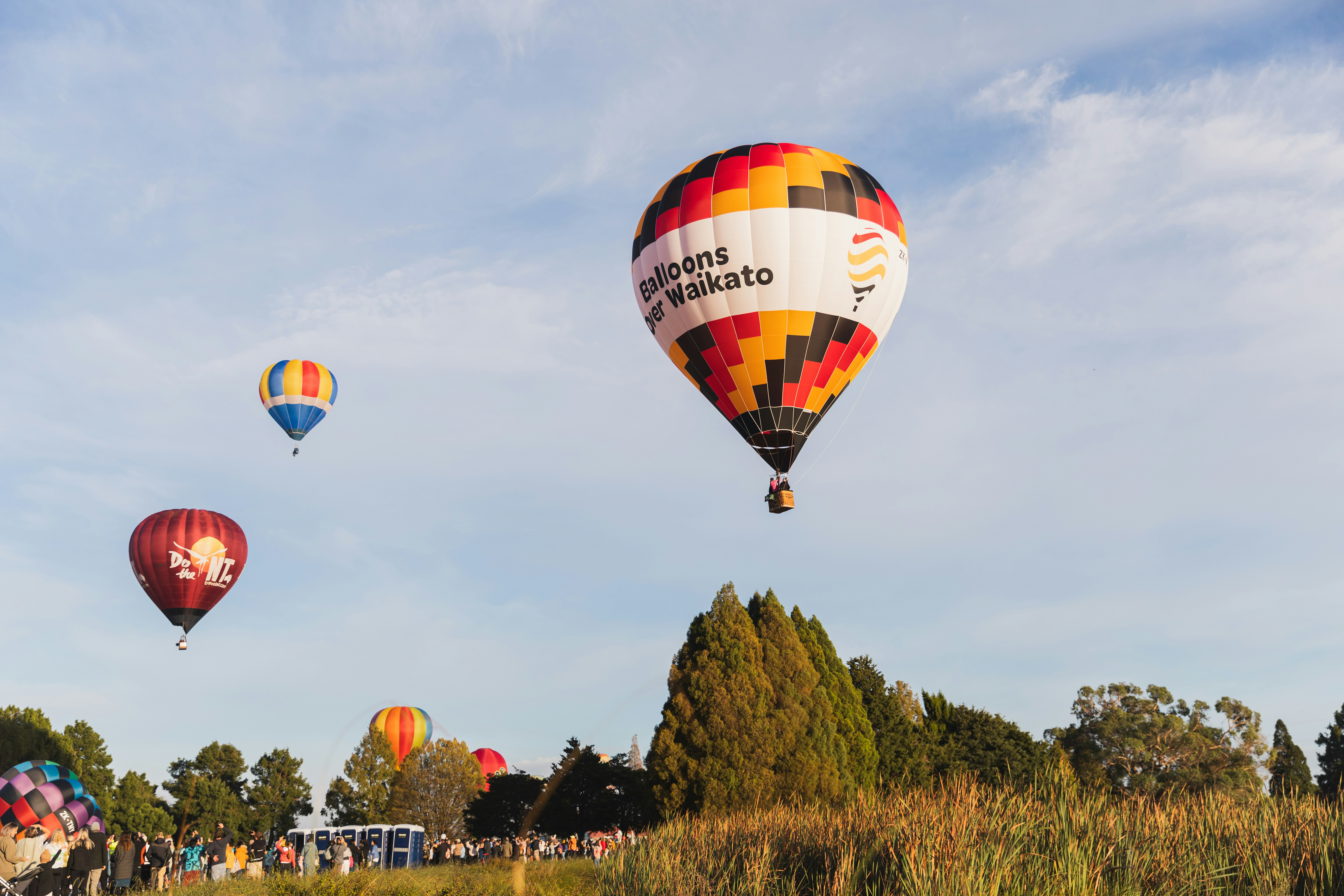 a group of hot air balloons flying in the sky