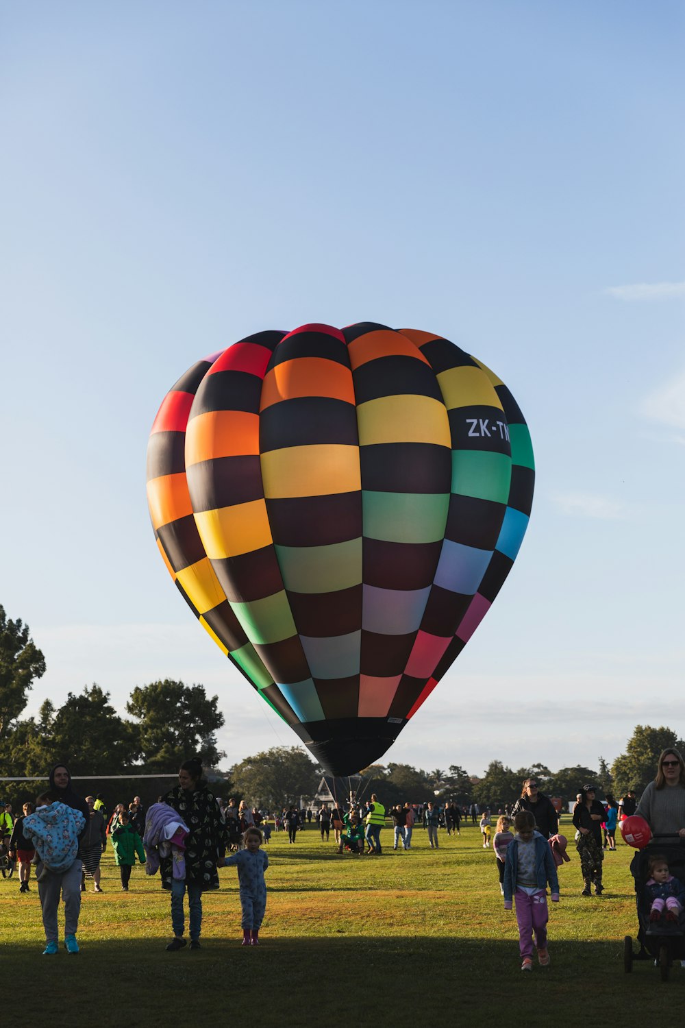 a group of people standing around a large hot air balloon