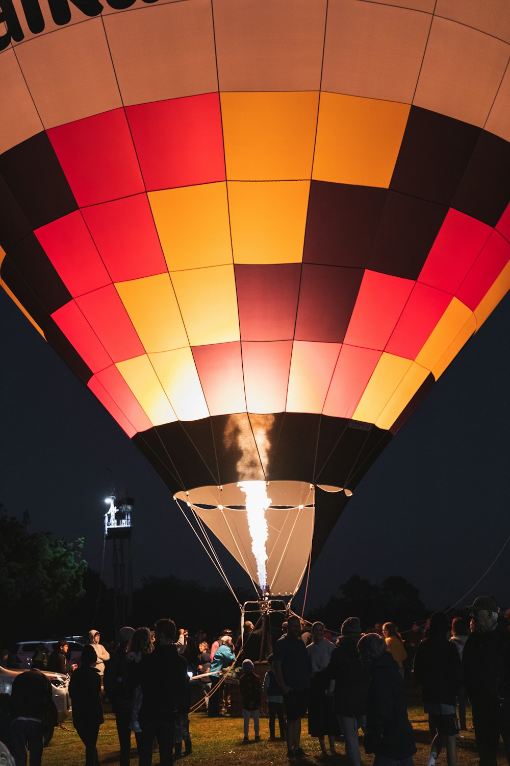 a group of people standing around a hot air balloon