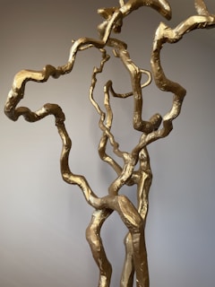 Elegant painting showcasing subtle textures and fine golden lines on a neutral background.