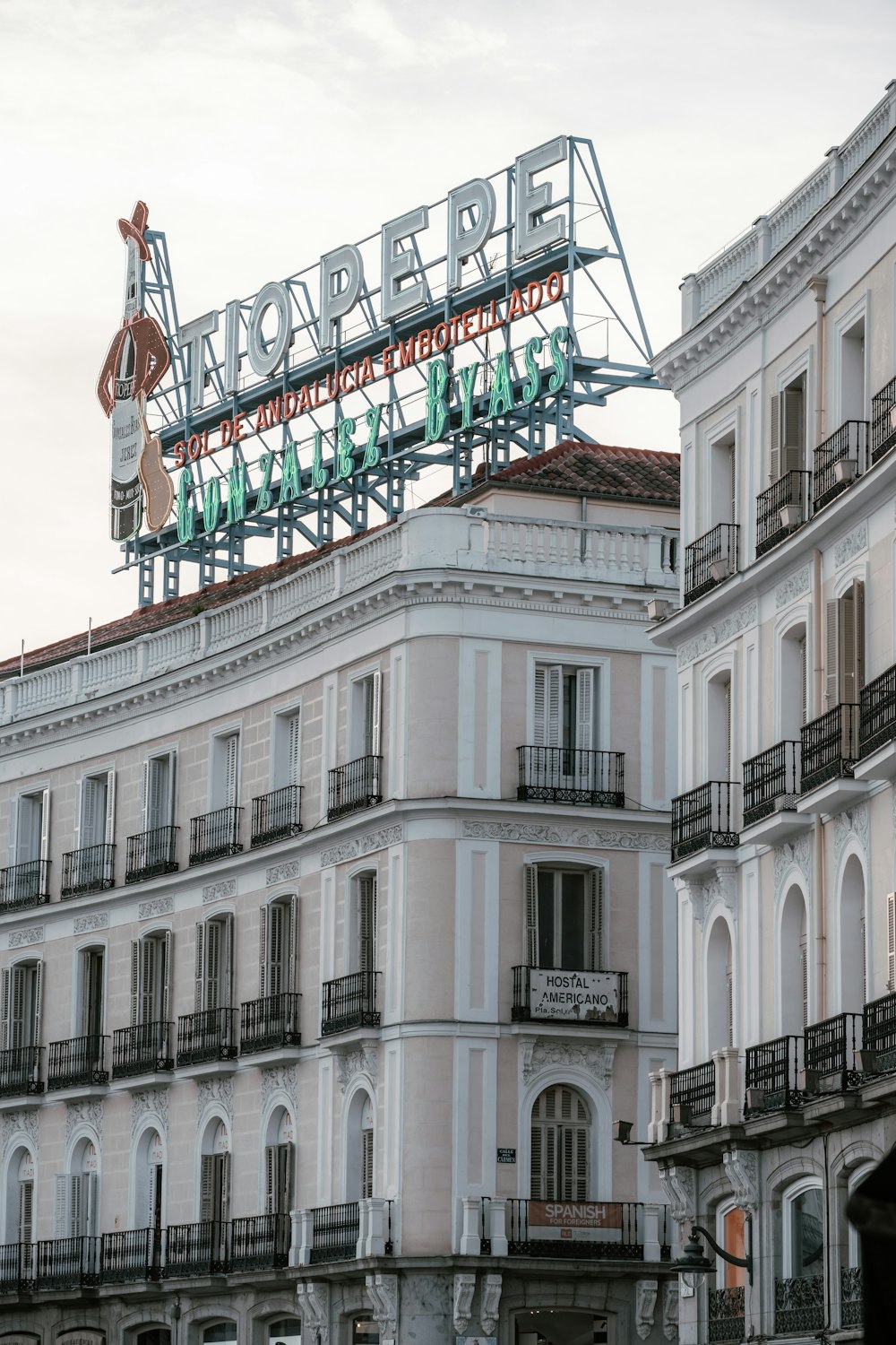 a large building with a neon sign on top of it