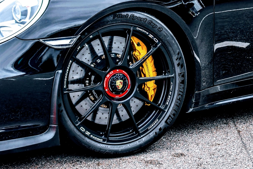 a close up of a black sports car tire