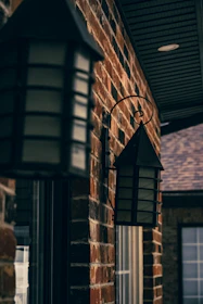 Close-up of a weatherproof wall sconce with a classic lighthouse design.