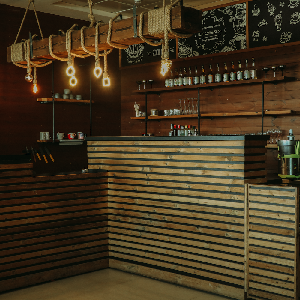a coffee shop with wooden slats and hanging lights
