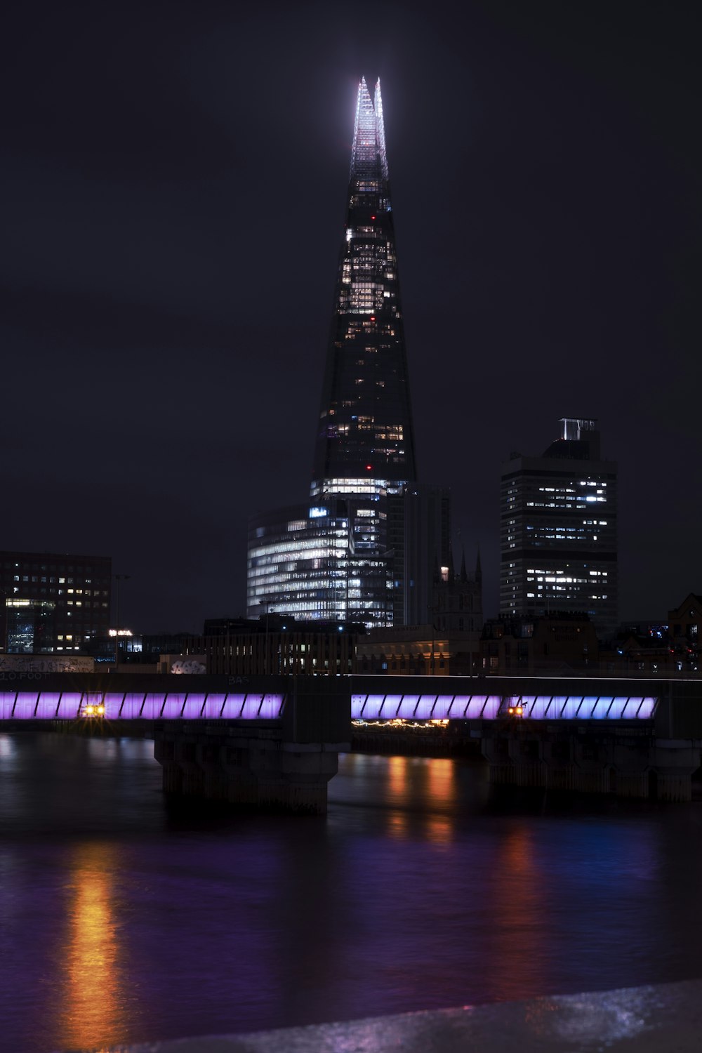 the shard of the building is lit up at night